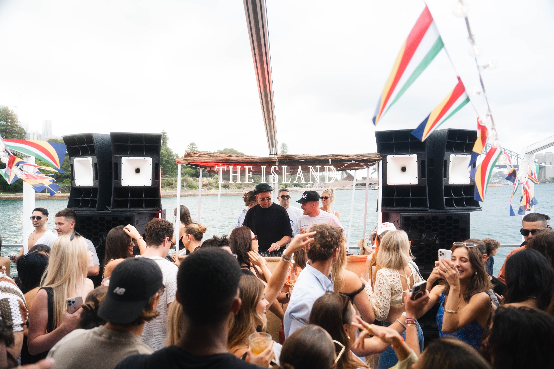 DJ set at The Island with crowd and Sydney Harbour backdrop