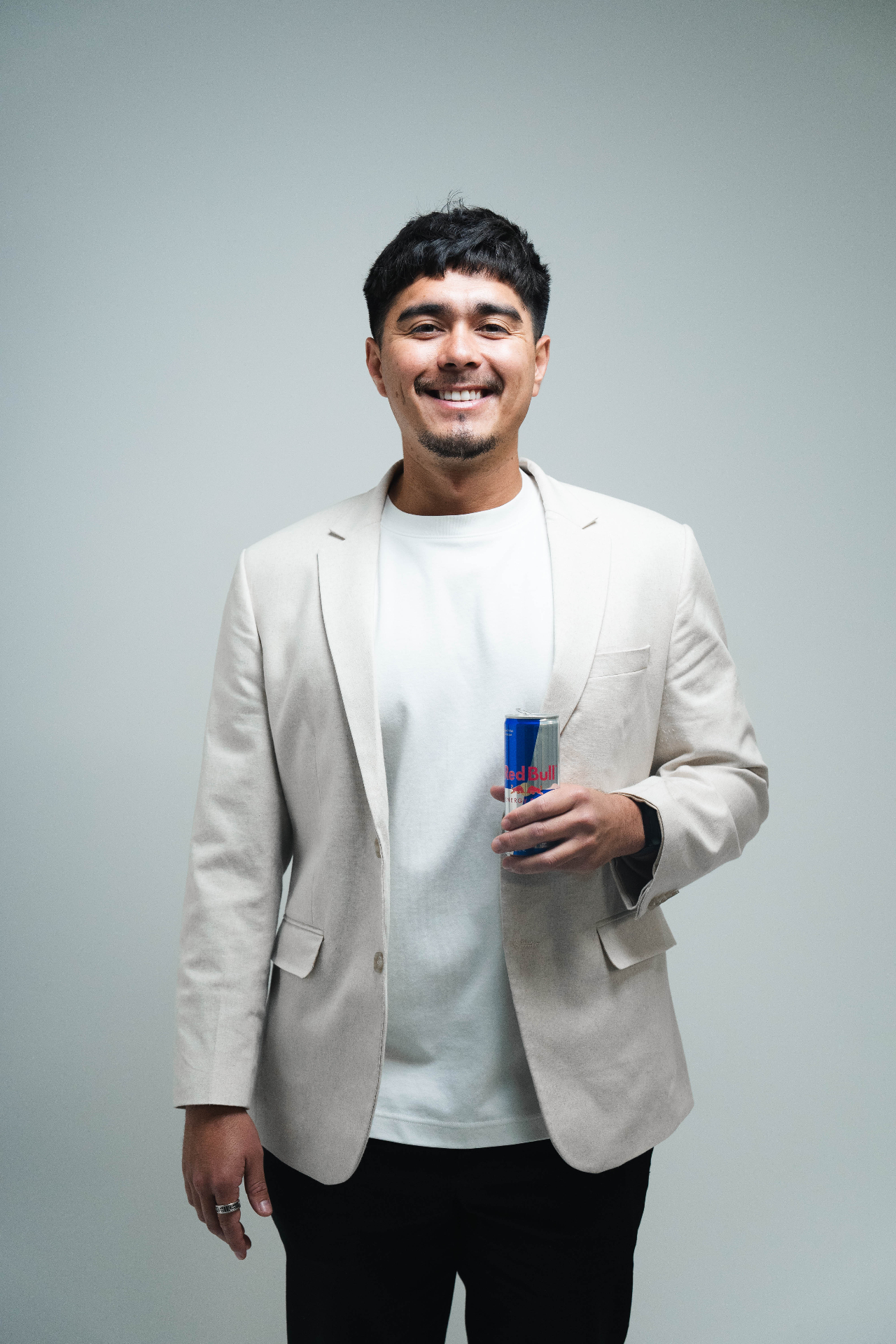 Studio portrait holding Red Bull can