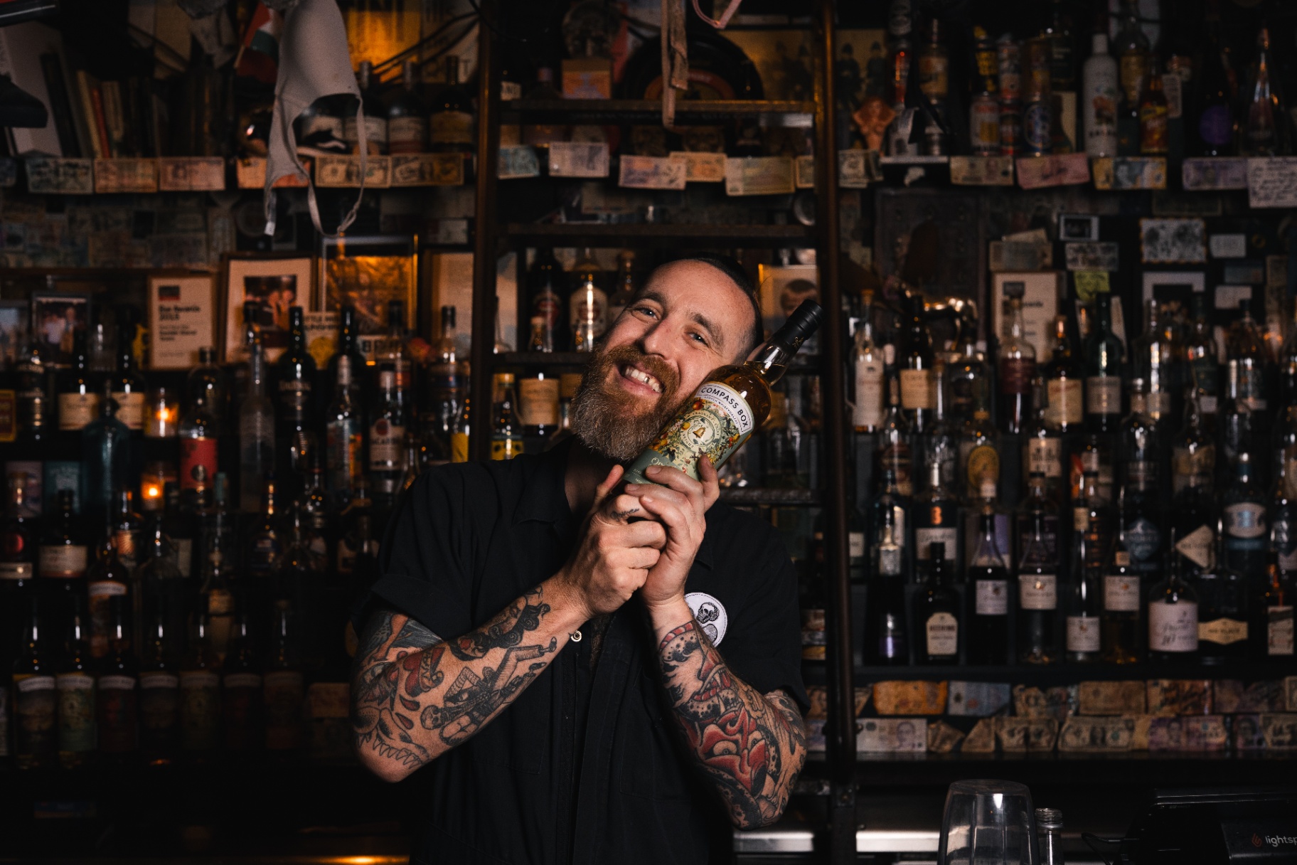 Bartender holding whisky bottle
