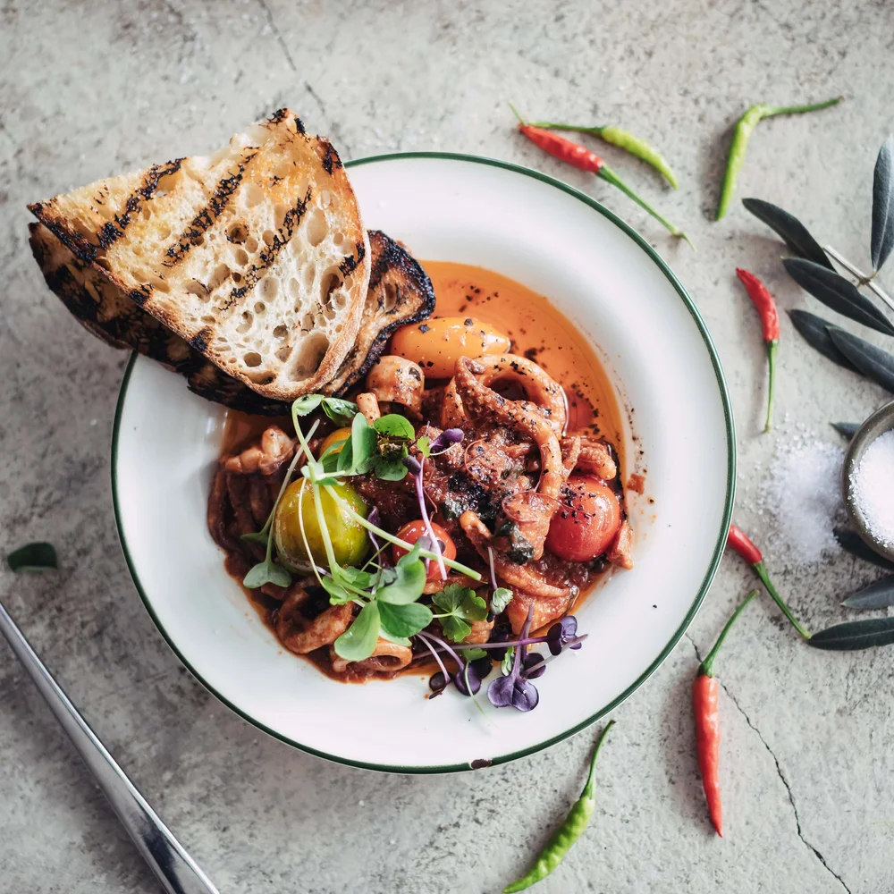 Calamari with charred sourdough and heirloom tomatoes