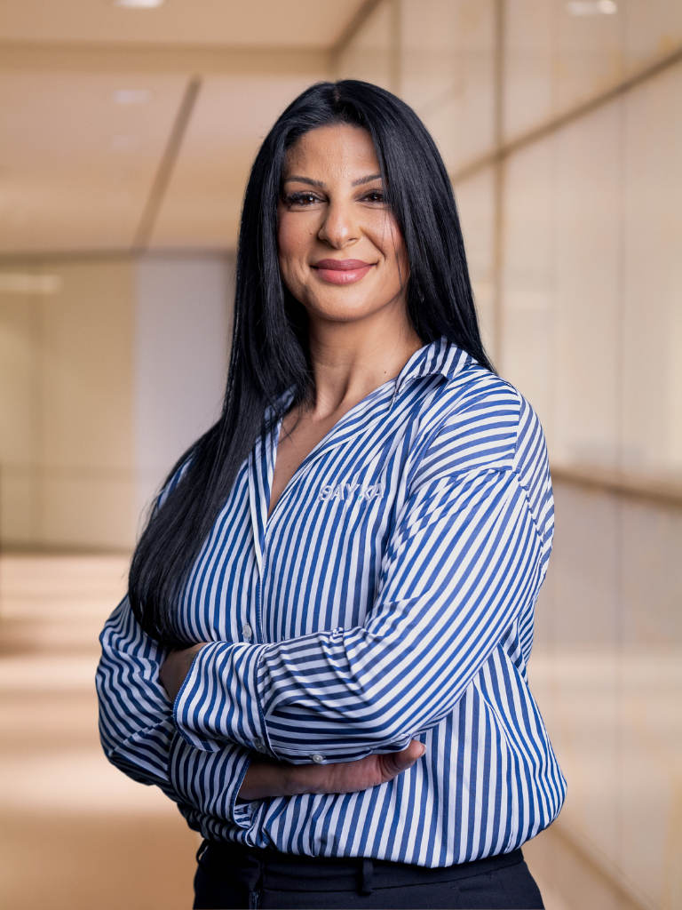 Corporate portrait in striped shirt, arms crossed