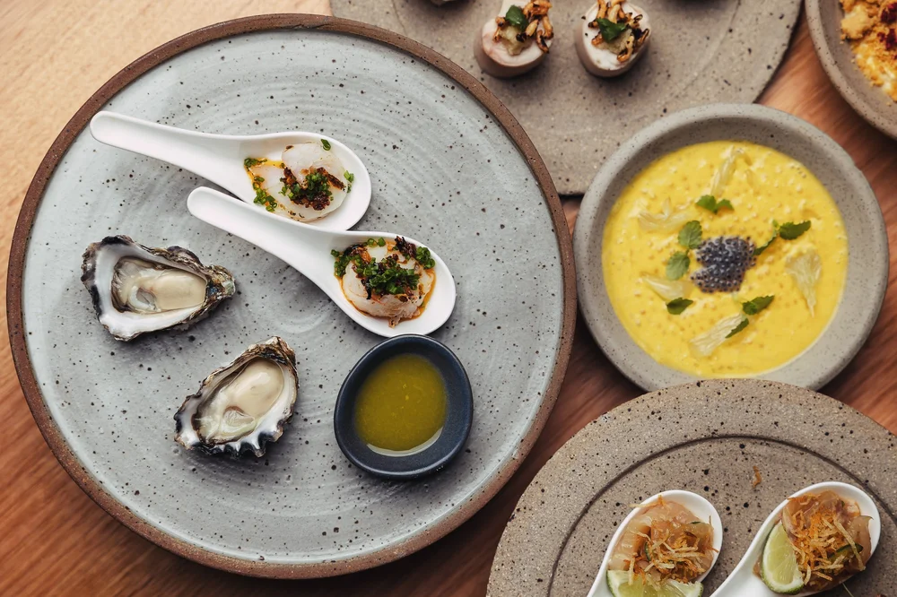 Oysters, scallops and mango soup fine-dining spread