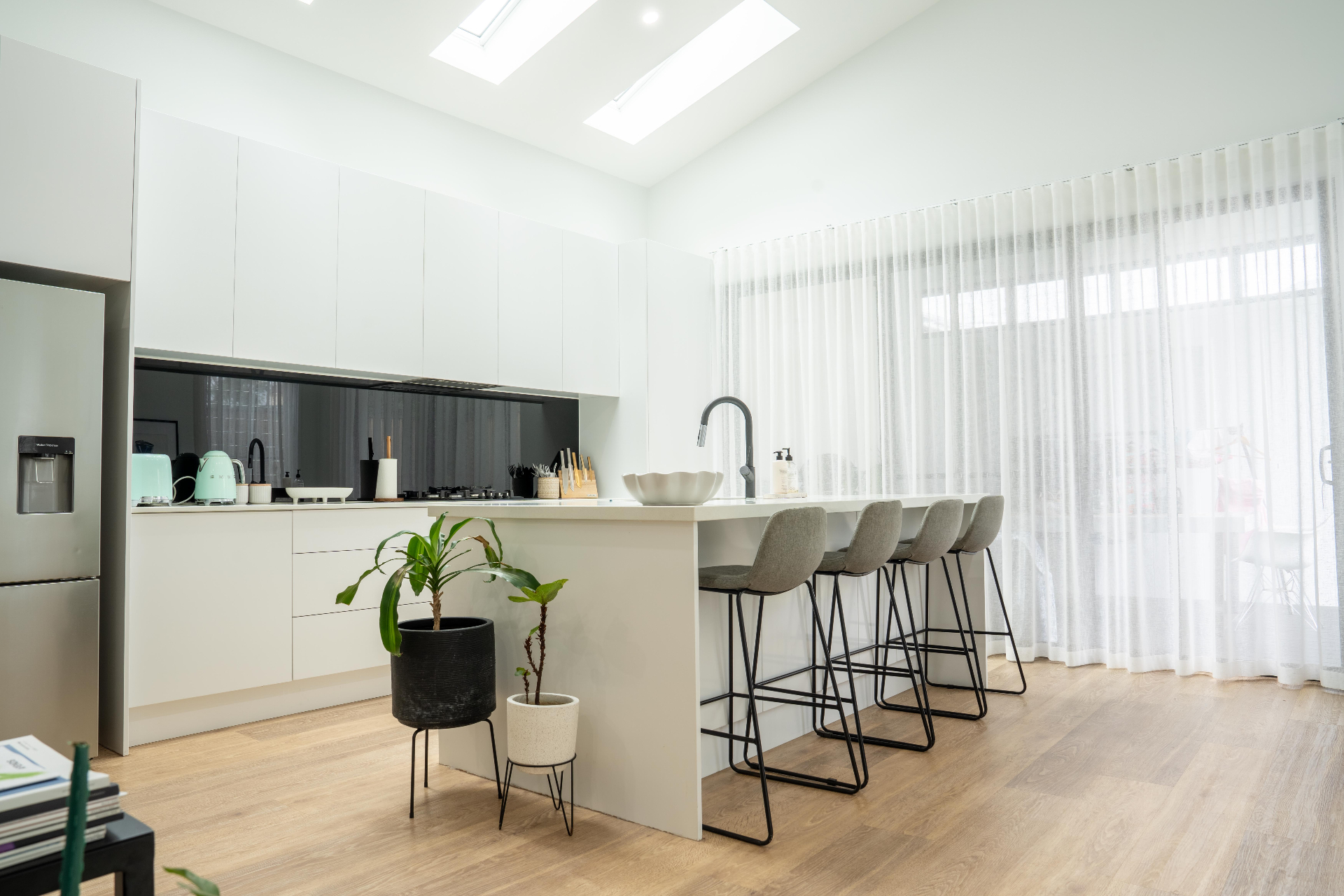 Modern white kitchen with skylights and island bench