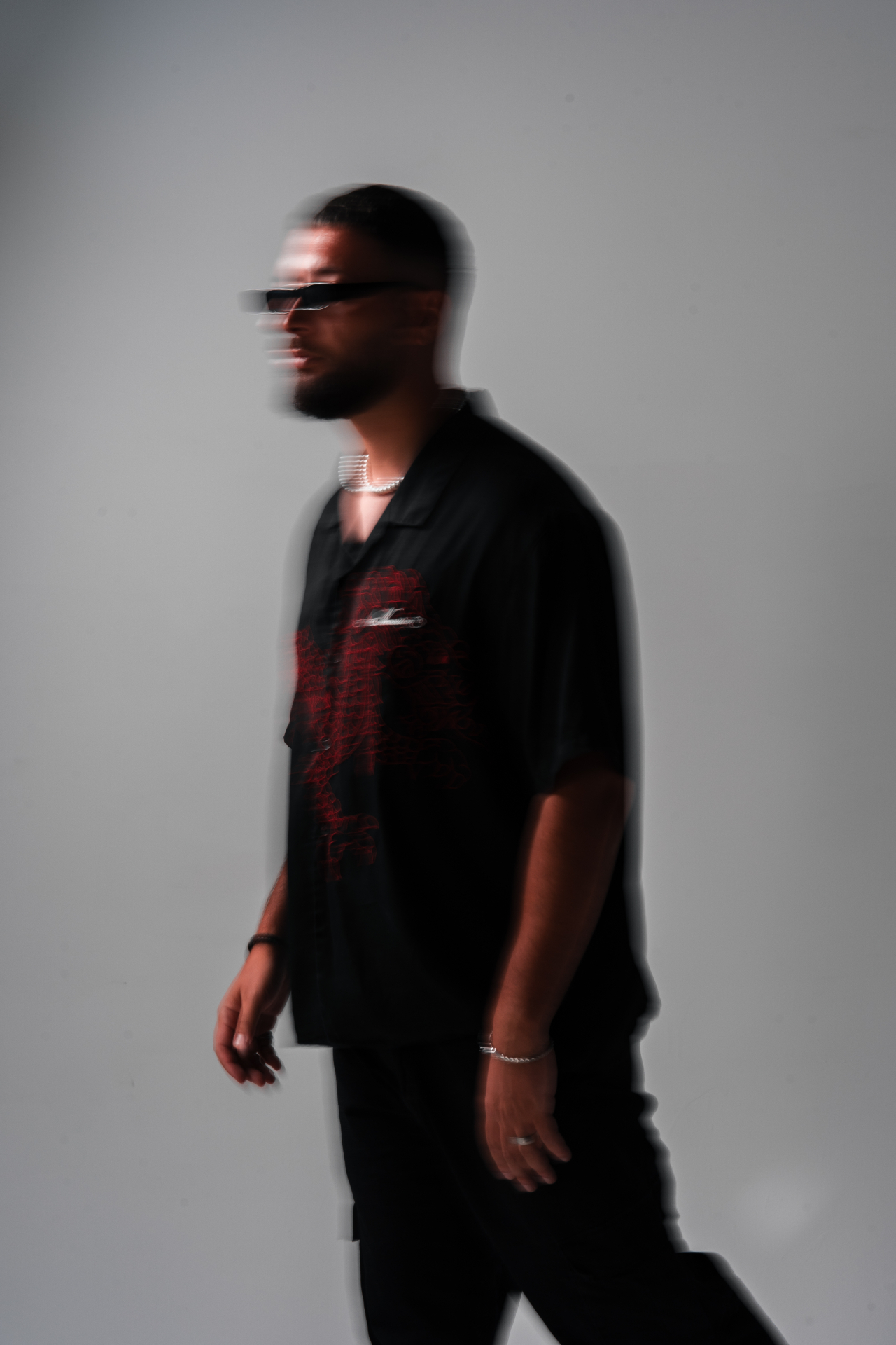 Editorial motion-blur portrait in black shirt with red print