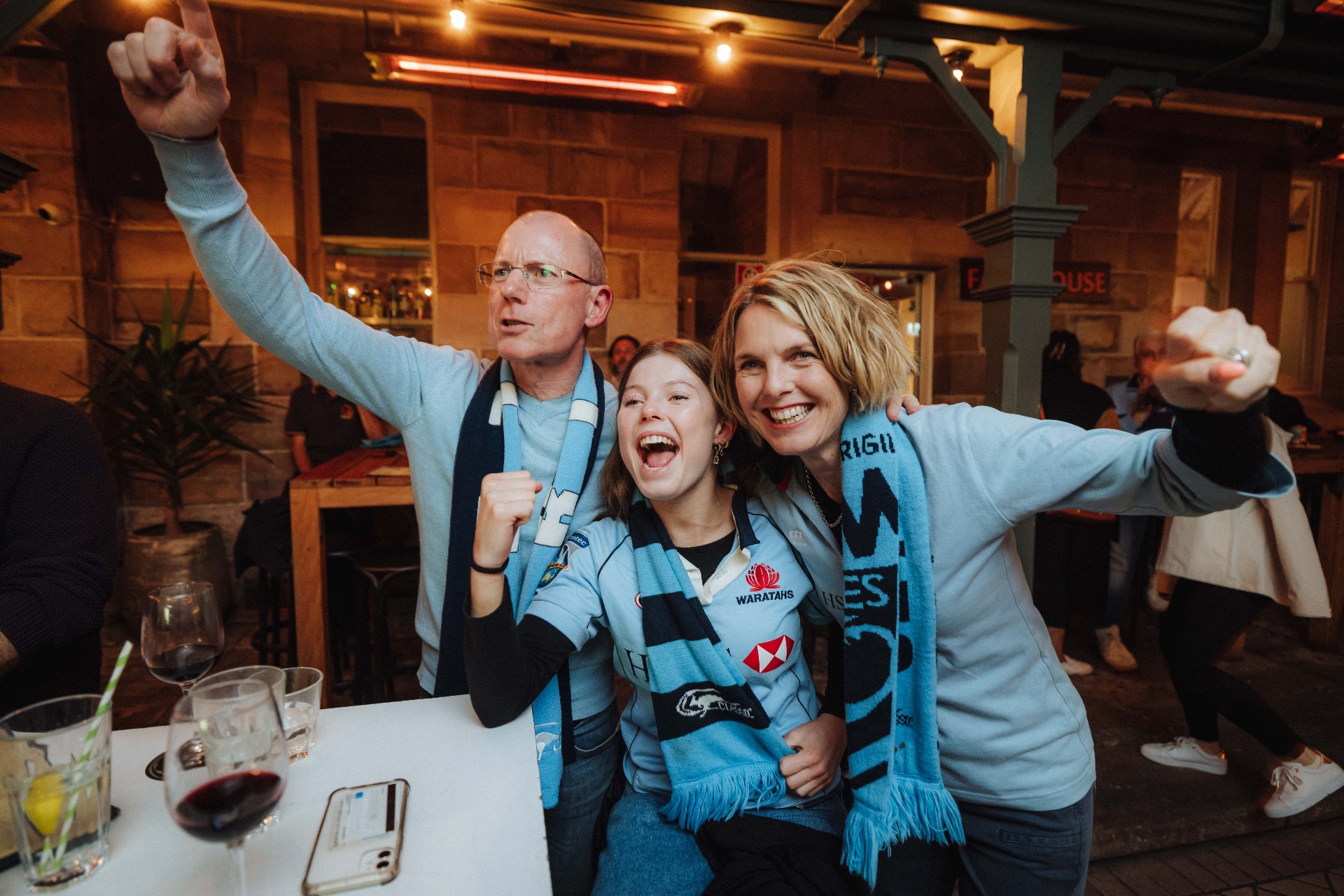 Rugby fans celebrating at a bar